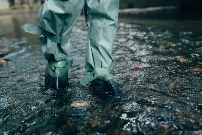Close up view of waterproof pants boots in water